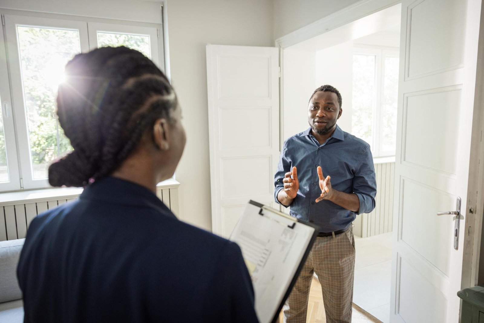 A staff and property owner having a discussion about his property for management